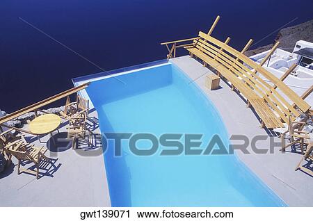 High angle view of a bench and chairs at the poolside View Large Photo Image Stock Image - High angle view of a bench and chairs at the poolside. Fotosearch