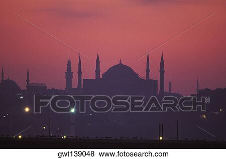 Silhouette of buildings in a city at night View Large Photo Image Stock Photo - Silhouette of buildings in a city at night. Fotosearch