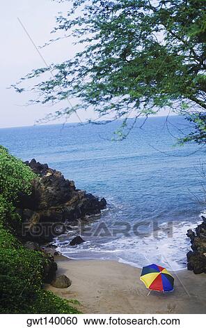 High angle view of a beach umbrella and rocks on the beach, Hawaii, USA View Large Photo Image Stock Image - High angle view of a beach umbrella and rocks on the beach, Hawaii, USA. Fotosearch