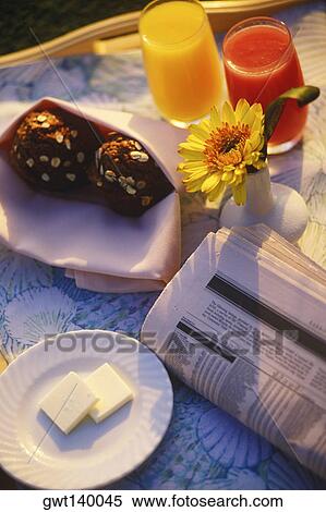 High angle view of two muffins and two glasses of juice near a newspaper View Large Photo Image Stock Photography - High angle view of two muffins and two glasses of juice near a newspaper. Fotosearch