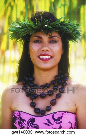 Stock Image - Portrait of a Hawaiian hula dancer smiling, Hawaii, USA. Fotosearch