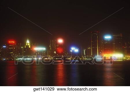Stock Photo - Buildings in a city lit up at night, Hong Kong, China. Fotosearch