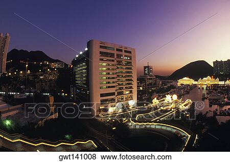 Stock Photo - High angle view of buildings in a city lit up at night, Hong Kong, China. Fotosearch