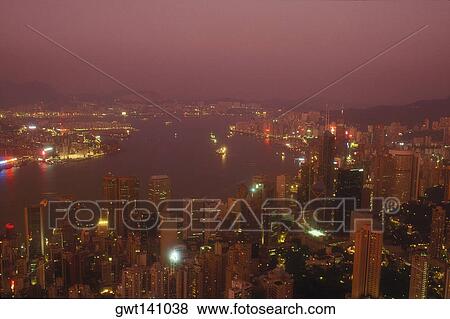 Stock Photo - High angle view of buildings in a city lit up at night, Hong Kong, China. Fotosearch