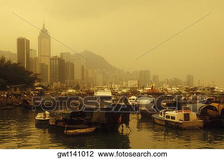 Stock Image - Houseboats moored at dock, Hong Kong, China. Fotosearch