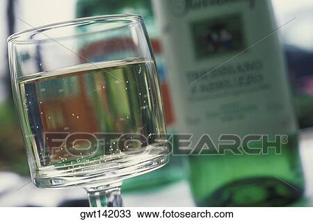 Close-up of a wine glass with a bottle of wine View Large Photo Image Stock Image - Close-up of a wine glass with a bottle of wine. Fotosearch