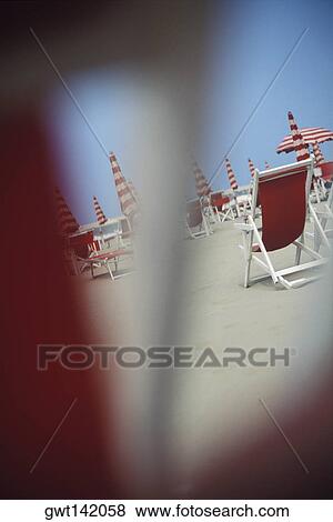 Folding chairs and beach umbrellas on the beach, Italy View Large Photo Image Stock Photo - Folding chairs and beach umbrellas on the beach, Italy. Fotosearch
