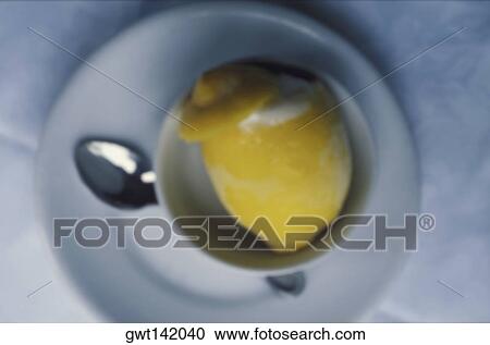 High angle view of a lemon and a spoon in a plate View Large Photo Image Stock Image - High angle view of a lemon and a spoon in a plate. Fotosearch