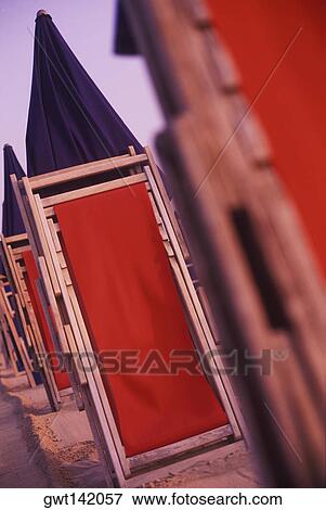 Row of folding chairs on the beach, Italy View Large Photo Image Stock Photo - Row of folding chairs on the beach, Italy. Fotosearch
