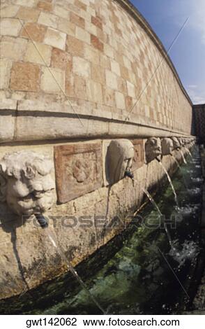 Water flowing from the mouth of statues at a water fountain View Large Photo Image Stock Image - Water flowing from the mouth of statues at a water fountain. Fotosearch