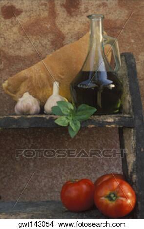 Bottle of olive oil and two tomatoes on a shelf View Large Photo Image Picture - Bottle of olive oil and two tomatoes on a shelf. Fotosearch
