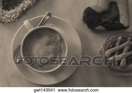 High angle view of a cup of coffee with snacks View Large Photo Image Stock Image - High angle view of a cup of coffee with snacks. Fotosearch