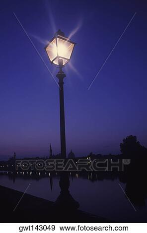 Lamppost lit up at night View Large Photo Image Stock Photo - Lamppost lit up at night. Fotosearch