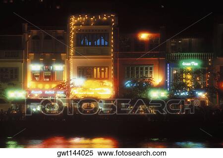 Buildings in a city lit up at night, Singapore View Large Photo Image Stock Photography - Buildings in a city lit up at night, Singapore. Fotosearch