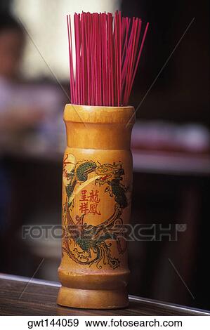 Stock Photo - Close-up of an incense stick stand on the table, Singapore. Fotosearch