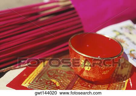Stock Image - Close-up of incense sticks and a bowl. Fotosearch
