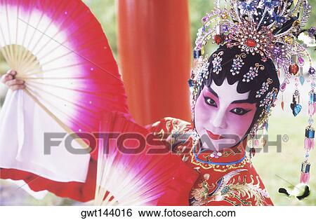 Portrait of a female Chinese opera performer holding folding fans, Singapore View Large Photo Image Stock Photograph - Portrait of a female Chinese opera performer holding folding fans, Singapore. Fotosearch