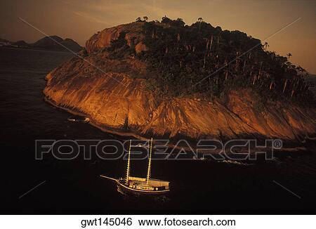 Aerial view of a boat in the sea at dusk View Large Photo Image Stock Photograph - Aerial view of a boat in the sea at dusk. Fotosearch