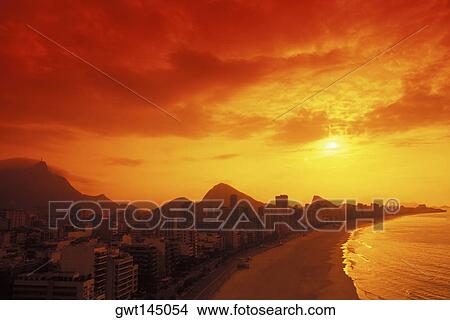 Aerial view of buildings by the sea at dusk View Large Photo Image Picture - Aerial view of buildings by the sea at dusk. Fotosearch