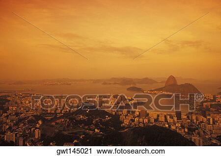 Stock Image - Aerial view of buildings in a city by the sea. Fotosearch