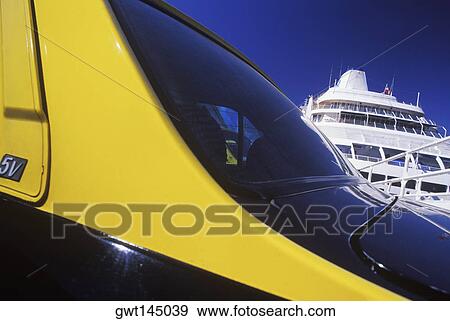 Stock Photo - Close-up of a car in front of a yacht. Fotosearch