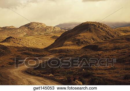 Dirt road through a landscape View Large Photo Image Stock Image - Dirt road through a landscape. Fotosearch