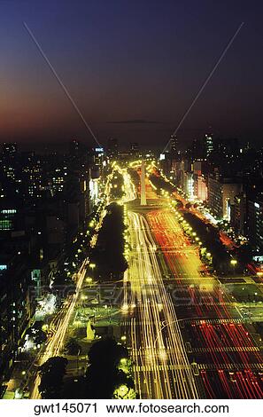 High angle view of buildings in a city lit up at night View Large Photo Image Stock Image - High angle view of buildings in a city lit up at night. Fotosearch