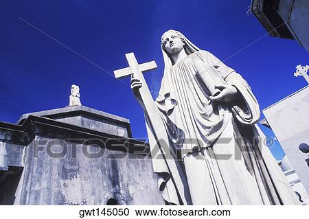 Low angle view of a statue of Virgin Mary with a cross View Large Photo Image Stock Image - Low angle view of a statue of Virgin Mary with a cross. Fotosearch