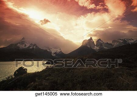Rainy clouds over mountains at dusk View Large Photo Image Stock Photography - Rainy clouds over mountains at dusk. Fotosearch