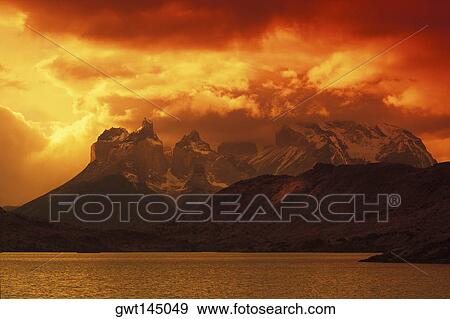 Rainy clouds over mountains by the sea at dusk View Large Photo Image Stock Photo - Rainy clouds over mountains by the sea at dusk. Fotosearch