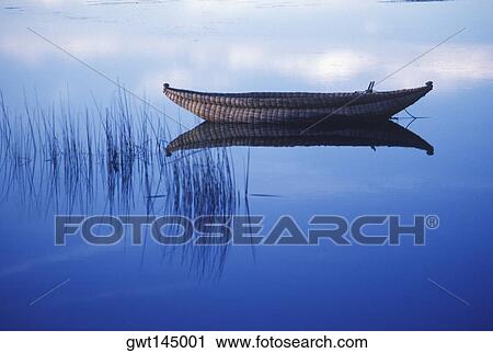 Stock Image - Reflection of a boat in a lake. Fotosearch