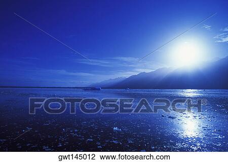 Stock Image - Sunrise over a mountain. Fotosearch
