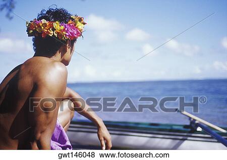 Close-up of a young man looking at a boat, Hawaii, USA View Large Photo Image Stock Photo - Close-up of a young man looking at a boat, Hawaii, USA. Fotosearch
