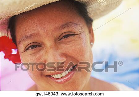 Portrait of a mid adult woman wearing a flower, Hawaii, USA View Large Photo Image Stock Image - Portrait of a mid adult woman wearing a flower, Hawaii, USA. Fotosearch