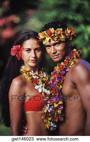 Stock Image - Portrait of a young couple standing together, Hawaii, USA. Fotosearch
