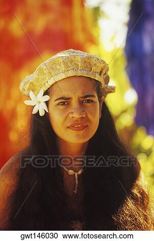 Stock Image - Portrait of a young woman wearing a cap, Hawaii, USA. Fotosearch
