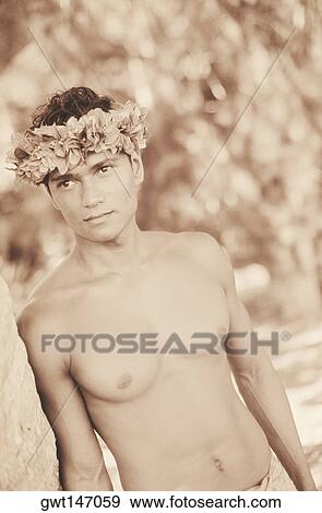 Close-up of a young man leaning against a tree, Hawaii, USA View Large Photo Image Stock Photo - Close-up of a young man leaning against a tree, Hawaii, USA. Fotosearch