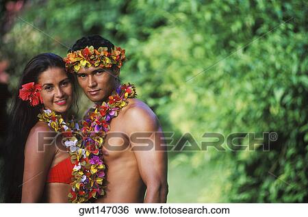 Portrait of a young couple standing together wearing garlands, Hawaii, USA View Large Photo Image Stock Photograph - Portrait of a young couple standing together wearing garlands, Hawaii, USA. Fotosearch