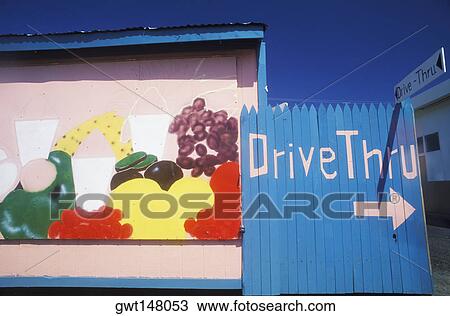 Stock Image - Arrow sign on a picket fence, Texas, USA. Fotosearch