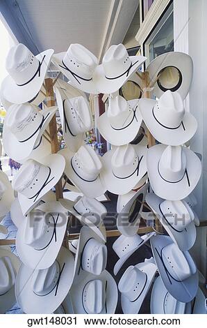 Stock Image - Cowboy hats hanging in a hat shop, Texas, USA. Fotosearch