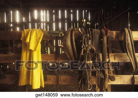 Horse saddle hanging on a fence View Large Photo Image Stock Photo - Horse saddle hanging on a fence. Fotosearch