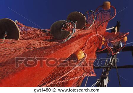 Stock Image - Low angle view of a commercial fishing net. Fotosearch