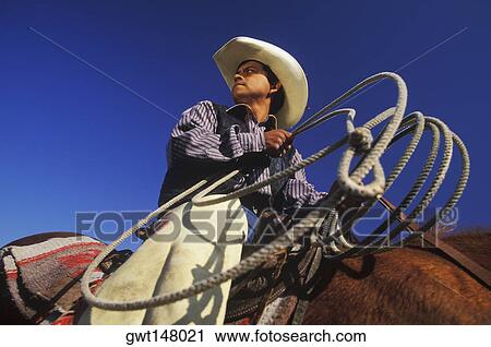 Low angle view of a cowboy riding a horse, Texas, USA View Large Photo Image Stock Image - Low angle view of a cowboy riding a horse, Texas, USA. Fotosearch