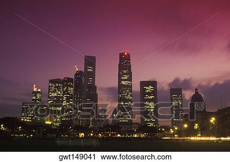 Skyscrapers in a city lit up at night View Large Photo Image Stock Image - Skyscrapers in a city lit up at night. Fotosearch