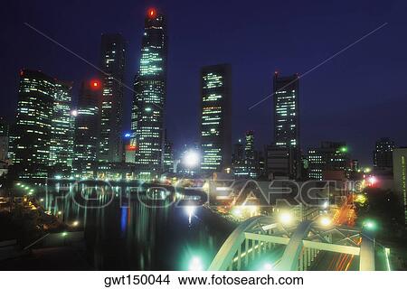 Buildings at the waterfront lit up at night View Large Photo Image Picture - Buildings at the waterfront lit up at night. Fotosearch