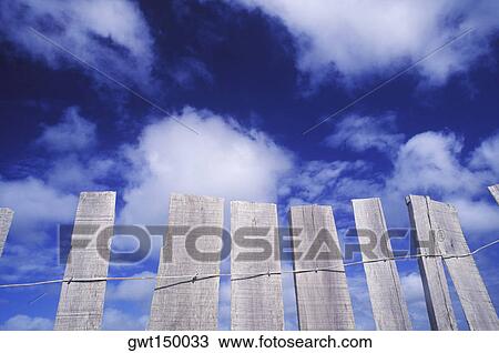 Low angle view of a wooden fence View Large Photo Image Stock Image - Low angle view of a wooden fence. Fotosearch