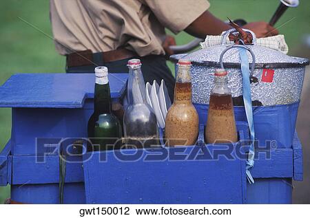 Mid section view of a man carrying a wooden box with bottles and a container on a bicycle View Large Photo Image Stock Image - Mid section view of a man carrying a wooden box with bottles and a container on a bicycle. Fotosearch