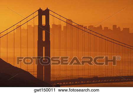 Stock Image - Silhouette of a suspension bridge. Fotosearch