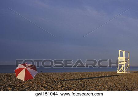 Lifeguard chair and beach umbrella on the beach View Large Photo Image Picture - Lifeguard chair and beach umbrella on the beach. Fotosearch