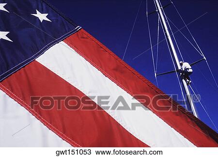 Low angle view of a man repairing a mast View Large Photo Image Stock Image - Low angle view of a man repairing a mast. Fotosearch